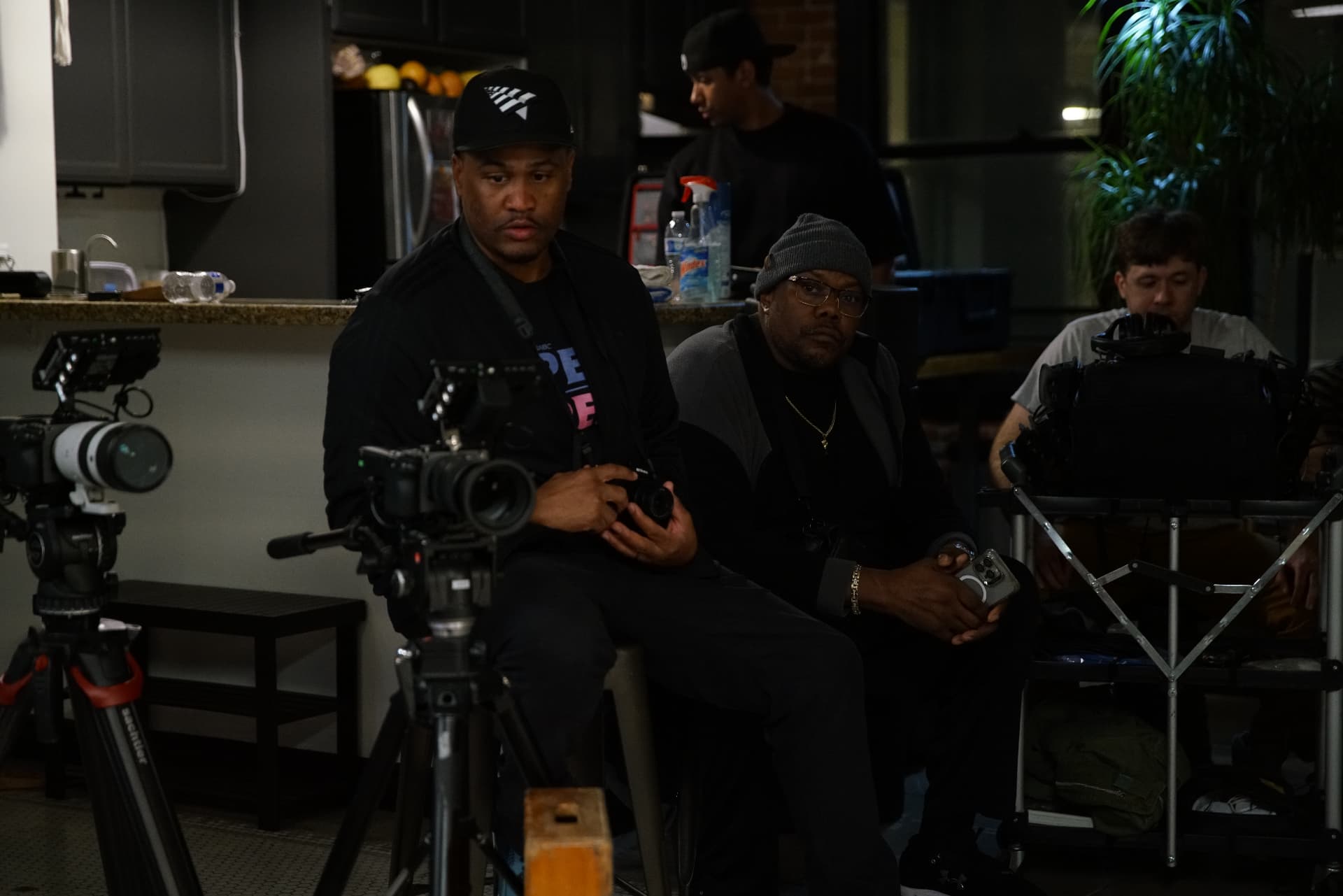 E'Ian West on set behind the cameras during production, reviewing a shot with the crew E'Ian West on set behind the cameras during production, reviewing a shot with the crew