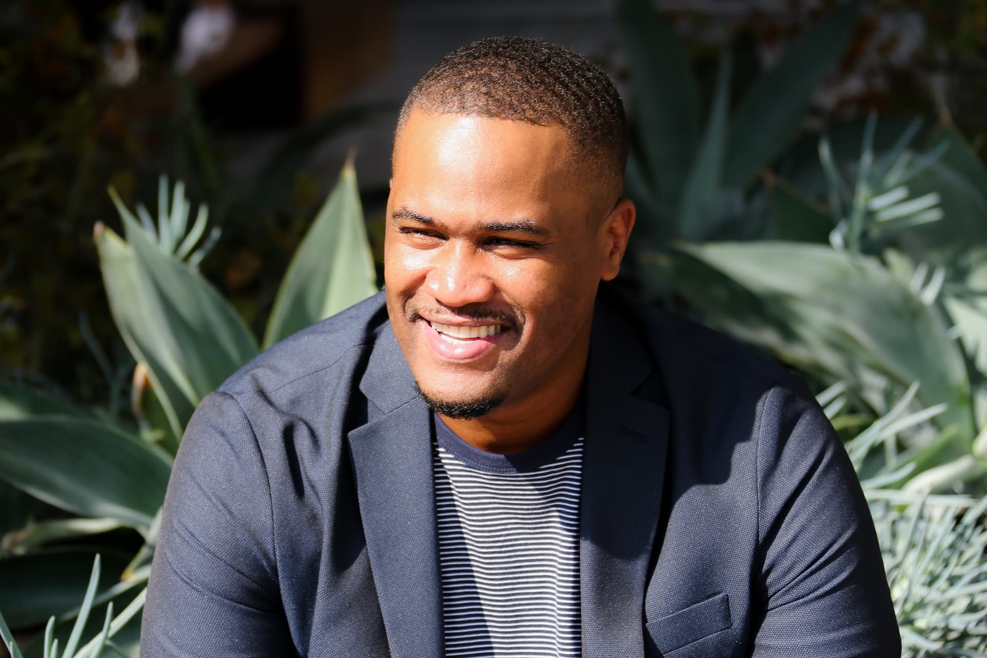E'Ian West, producer and director, smiling in an outdoor editorial portrait in Los Angeles E'Ian West, producer and director, smiling in an outdoor editorial portrait in Los Angeles