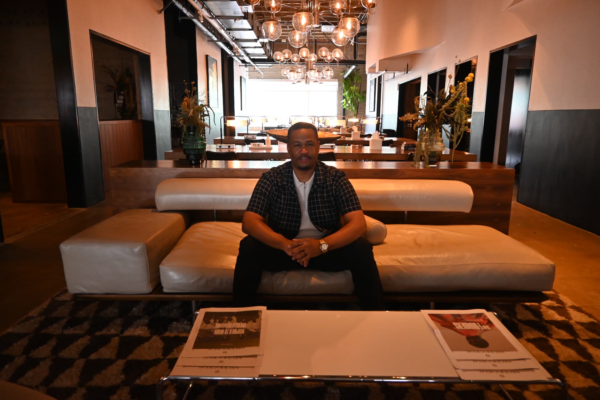 E'Ian West seated in a creative studio lounge during a production meeting E'Ian West seated in a creative studio lounge during a production meeting